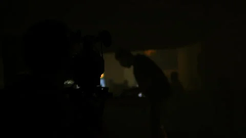 Video operator shooting DJ set concert at night silhouette scene videographer Stock Footage 111839835