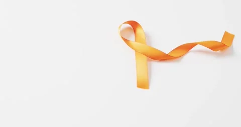 Video of orange multiple sclerosis awareness ribbon on white background with Stock Footage 331245943