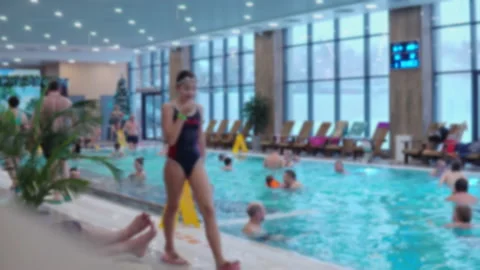 Video out of focus. People of different ages swim in the large pool of the aqua Stock Footage 169414375