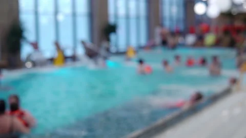 Video out of focus. People of different ages swim in the large pool of the aqua Stock Footage 169414761