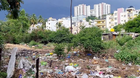 A video of outdoor garbage showing plastic waste, discarded clothing, veget.. Video stock 325648591