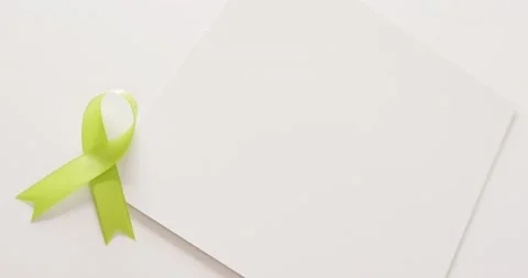Video of pale green std awareness ribbon and white card with copy space, on Stock Footage 221799759