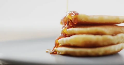 Video of pancakes with maple syrup on white plate seeing from above Stock Footage 336534310