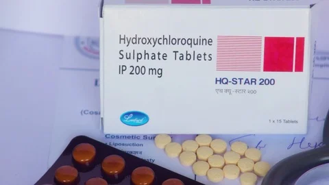 Video panning left to right on a box of hydroxychloroquine tablets Stock Footage 128874450