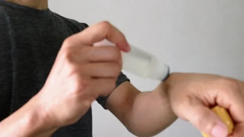 Video of a person applying a compress to their arm Stock Footage 324541559