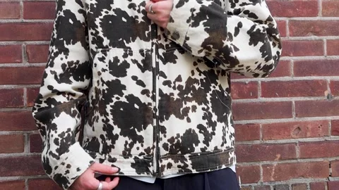 Video of a person pulling zipper of his jacket down and walking away. Stock Footage 336948839