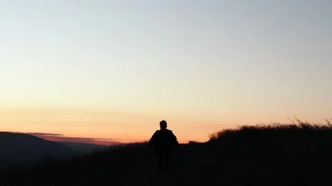 Video of a person running through the mountains of Peru at sunset. Stock Footage 249232174