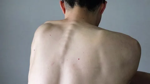 Video of a person stretching from behind 動画素材 323503446