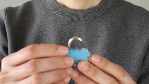 Video of a person unlocking a padlock Stock Footage 324543836