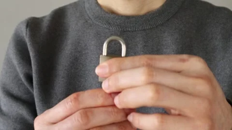 Video of a person unlocking a padlock Stock Footage 324544249