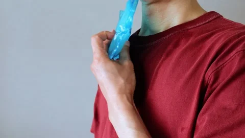 Video of a person using a fan and ice packs to cool their body Stock Footage 323502911