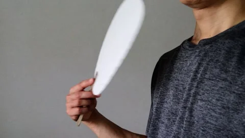 Video of a person using a fan Stock Footage 323503398