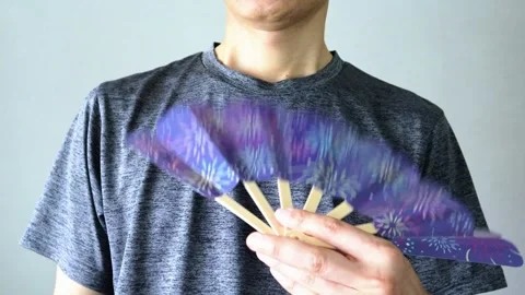 Video of a person using a folding fan Stock Footage 323503166