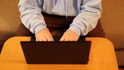Video of a person using a laptop to check cryptocurrency charts while typing Stock Footage 322095873