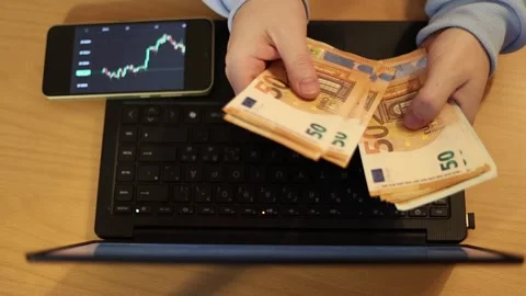 Video of a person using a laptop to check cryptocurrency charts while typing Stock Footage 322095899