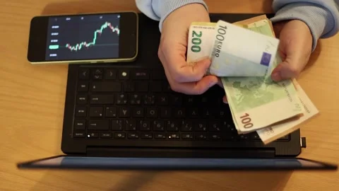 Video of a person using a laptop to check cryptocurrency charts while typing Stock Footage 322095900