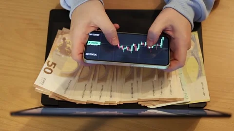 Video of a person using a laptop to check cryptocurrency charts while typing Video stock 322095938
