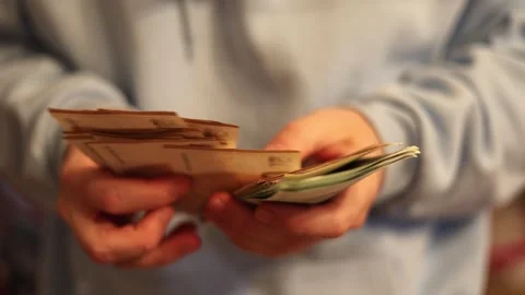Video of a person using a laptop to check cryptocurrency charts while typing Stock Footage 322095970