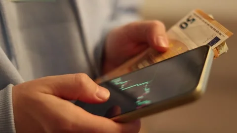 Video of a person using a laptop to check cryptocurrency charts while typing Stock Footage 322095980