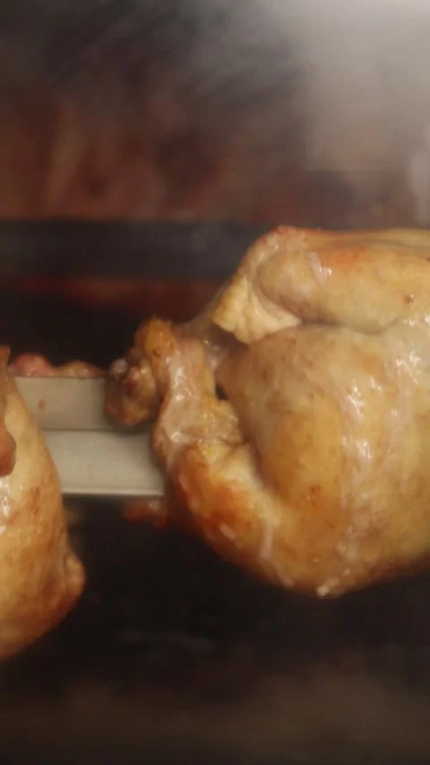 Video of peruvian food called "pollo a la brasa" going around in an oven. Stock Footage 231541340