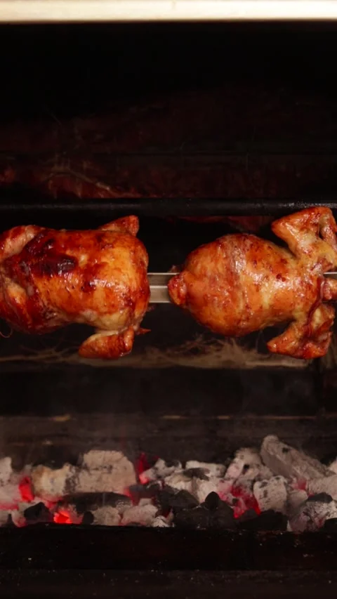 Video of peruvian food called "pollo a la brasa" going around in an oven. Stock Footage 231541374