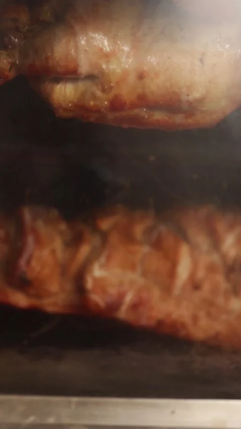 Video of peruvian food called "pollo a la brasa" and pork ribs in an oven. Stock Footage 231541375
