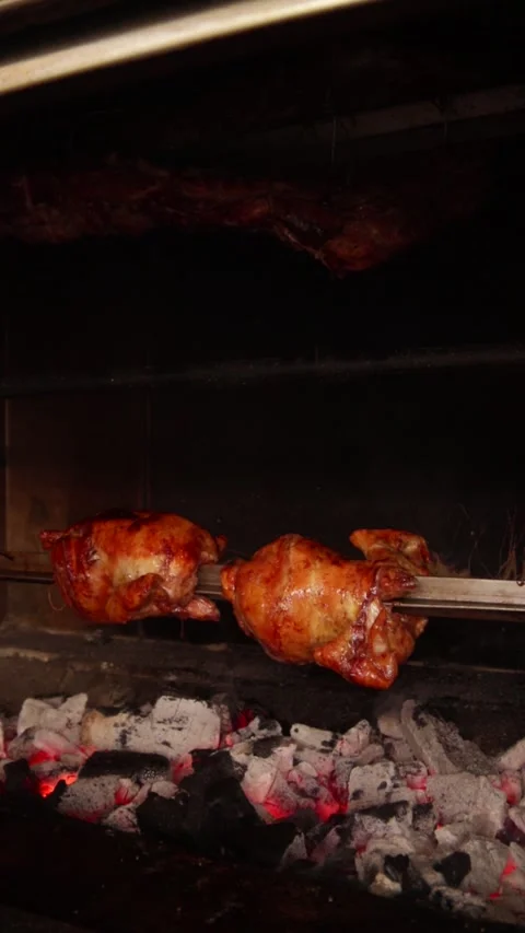 Video of peruvian food called "pollo a la brasa" going around in an oven. Stock Footage 231541396