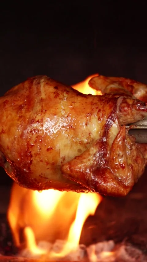 Video of peruvian food called "pollo a la brasa" going around in an oven. Stock Footage 231541437