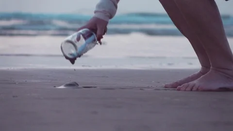 Video of picking up message in the bottle in real slow motion Stock Footage 79203740