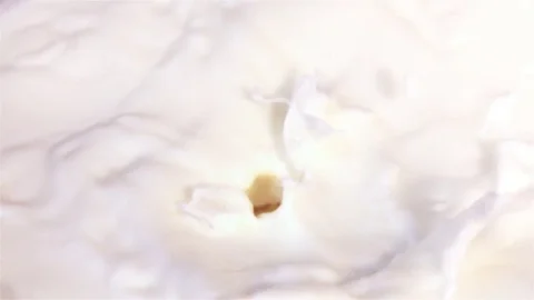 Video of pieces of pineapple falling into milk in real slow motion Stock Footage 79522463