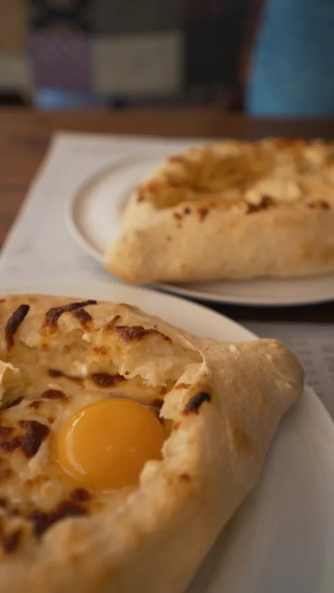 Video of pizzas with eggs on plates, closeups, ideal for food themes Stock Footage 279818889