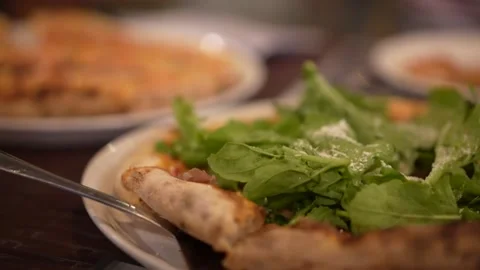 Video of pizzas on the table and people getting a slice Stock Footage 149668937
