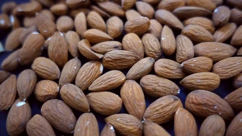VIDEO, plate with raw brown almonds, heathy food or snack Stock Footage 101667467