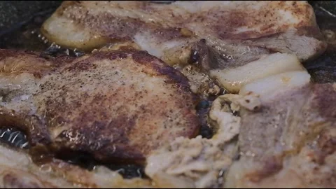 Video of pork chops cooking in a pan, viewers can almost smell the aroma Stock Footage 279913059