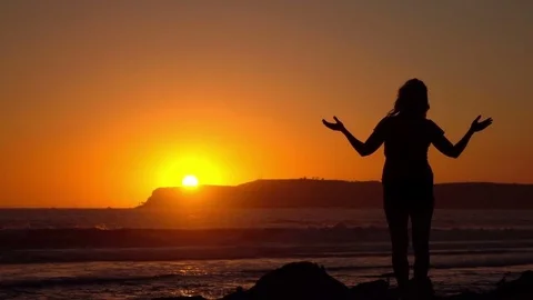 Video of practicing yoga at the sunset in real slow motion Stock Footage 74002066