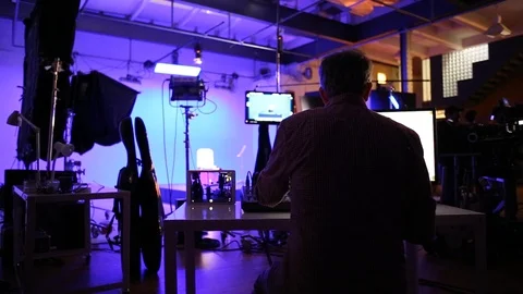 A video production team on location in a studio environment Stock Footage