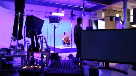 A video production team on location in a studio environment Stock Footage 89506173