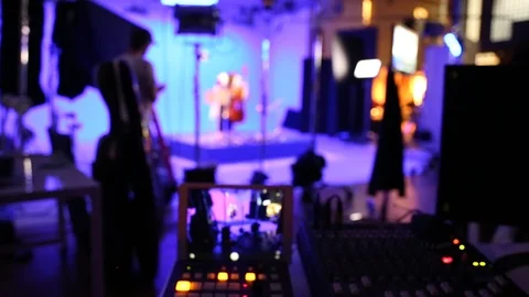 A video production team on location in a studio environment Stock Footage 89506191
