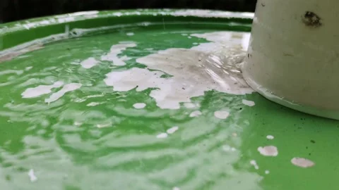 Video of raindrops falling on a bucket Stock Footage 221227400