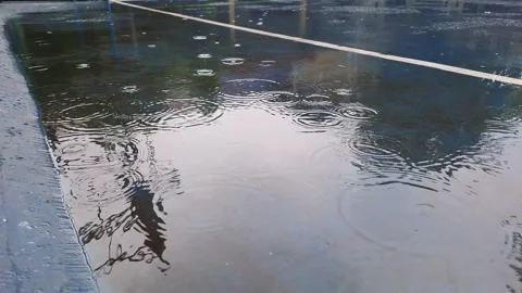 Video of raindrops on a school field Stock Footage 296024946