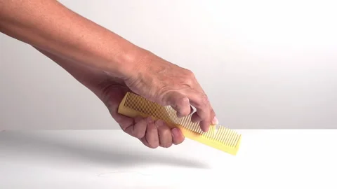 Video with real sound effect of  Finger running along plastic comb teeth Stock Footage 328641242
