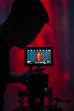 Video recording process. Operator is filming young man on a professional came 스톡 사진