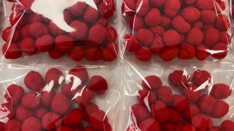 Video of red cotton balls packaged in transparent plastic bags Stock Footage 317578319
