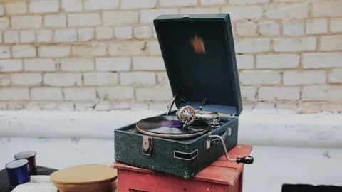 Video of a retro gramophone with a record standing on a chair and street Stock Footage 155494436