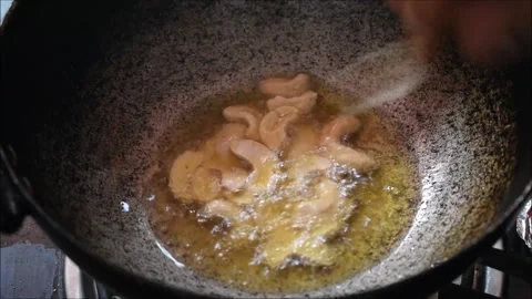 Video of roasting Cashew nuts in Ghee. It is used for making payasam a south Stock Footage 138514465