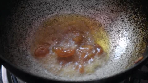 Video of roasting raisin or dried grape in Ghee. It is used for making payasa Stock Footage 138515626