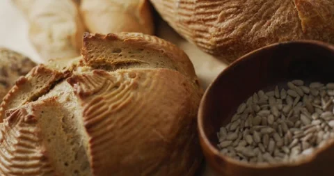 Video of rolls and bread on baking paper on wooden worktop Stock Footage 340766109