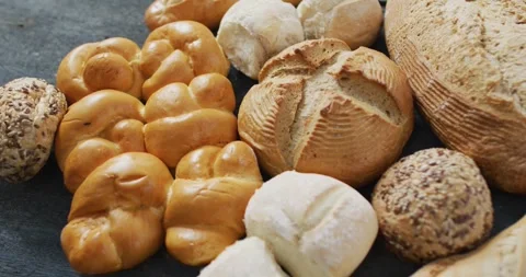 Video of rolls and bread on wooden worktop seeing from above Stock Footage 344534071