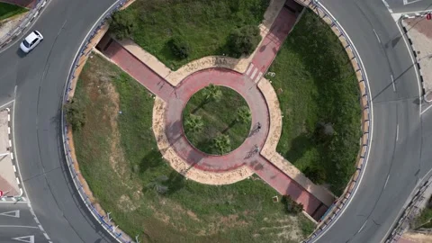 Video of roundabout  with bicycle lane inside on which ride cyclists Stock Footage 229700963