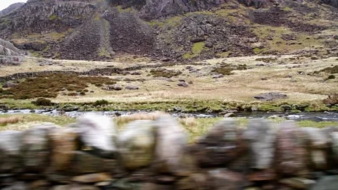 Video, Rugged Mountains with dry stone wall in foreground as if from moving car Stock Footage 204755314